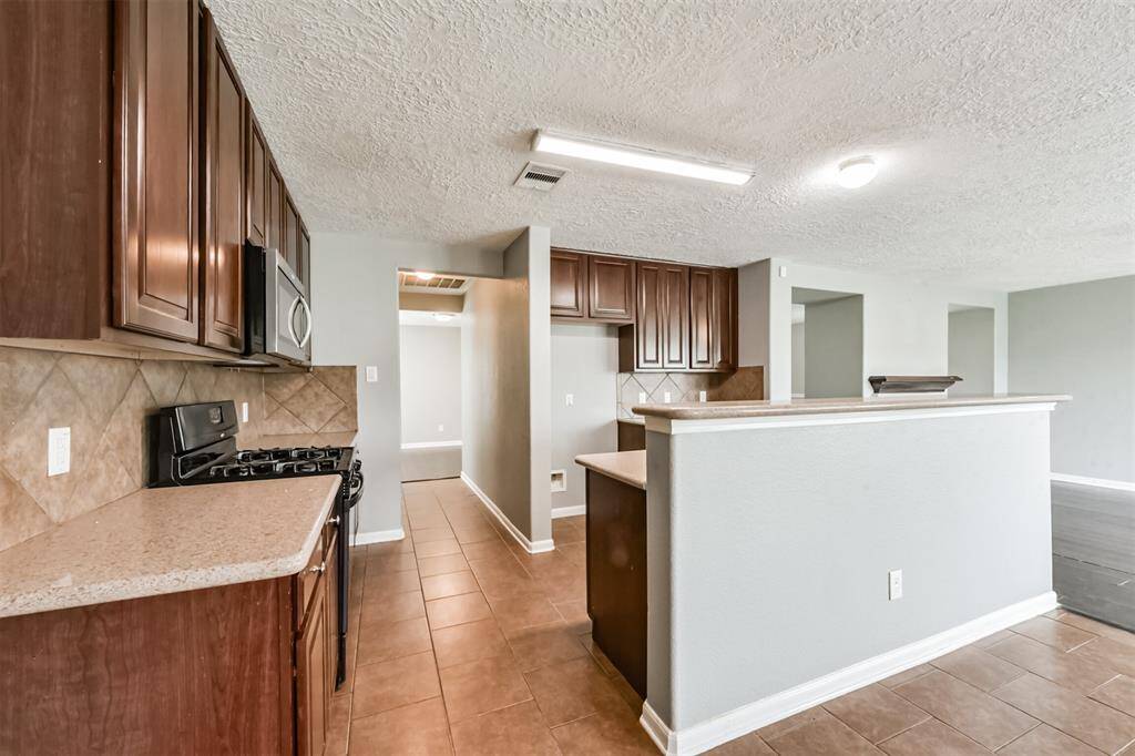 This kitchen features abundant cabinetry and generous counter space.