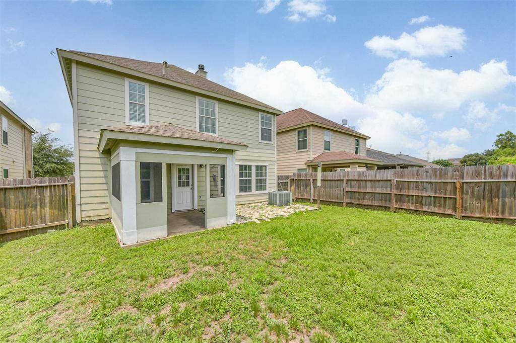 Expansive backyard with a covered patio and serene privacy—no neighbors behind.