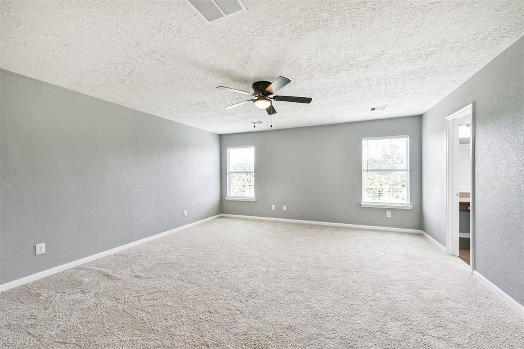 Luxurious primary bedroom featuring a private ensuite bathroom.