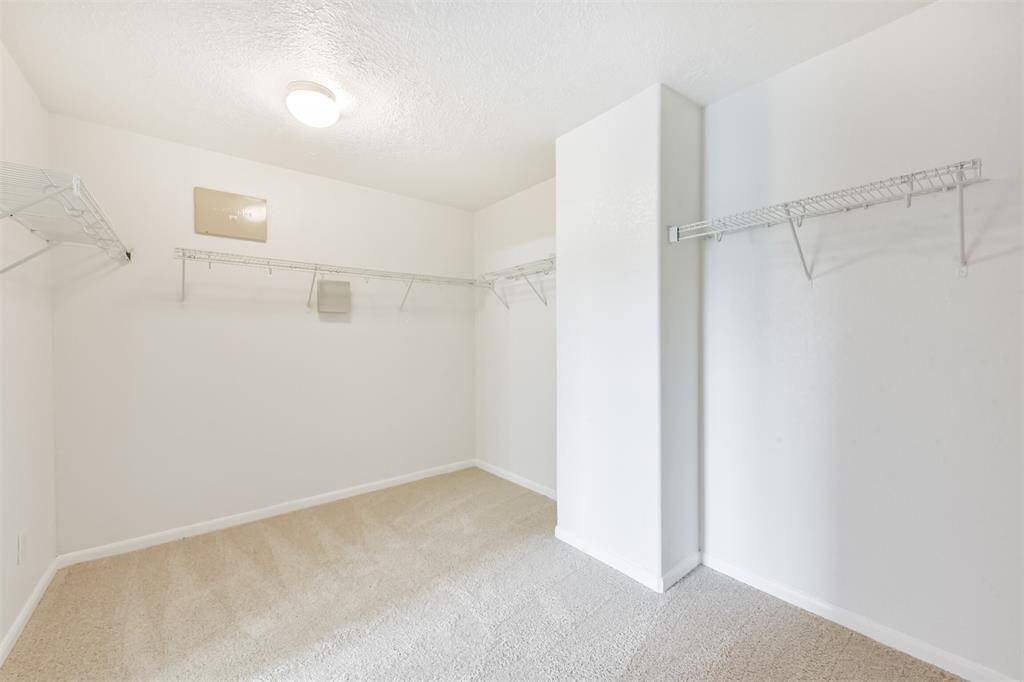 Spacious walk-in closet for the primary suite.