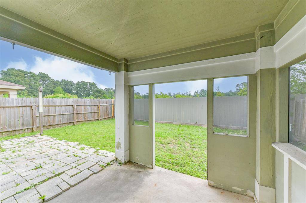 Enjoy outdoor living with this spacious covered patio, perfect for relaxing and entertaining.