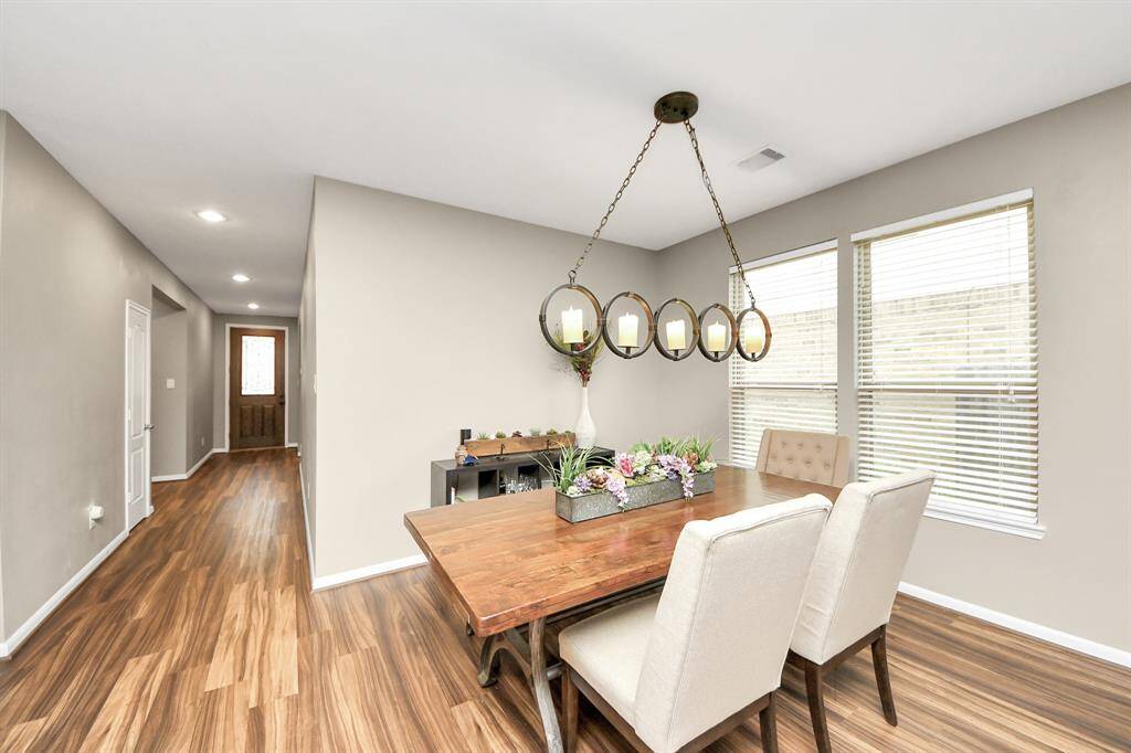 The dining room features large windows and beautiful lighting.