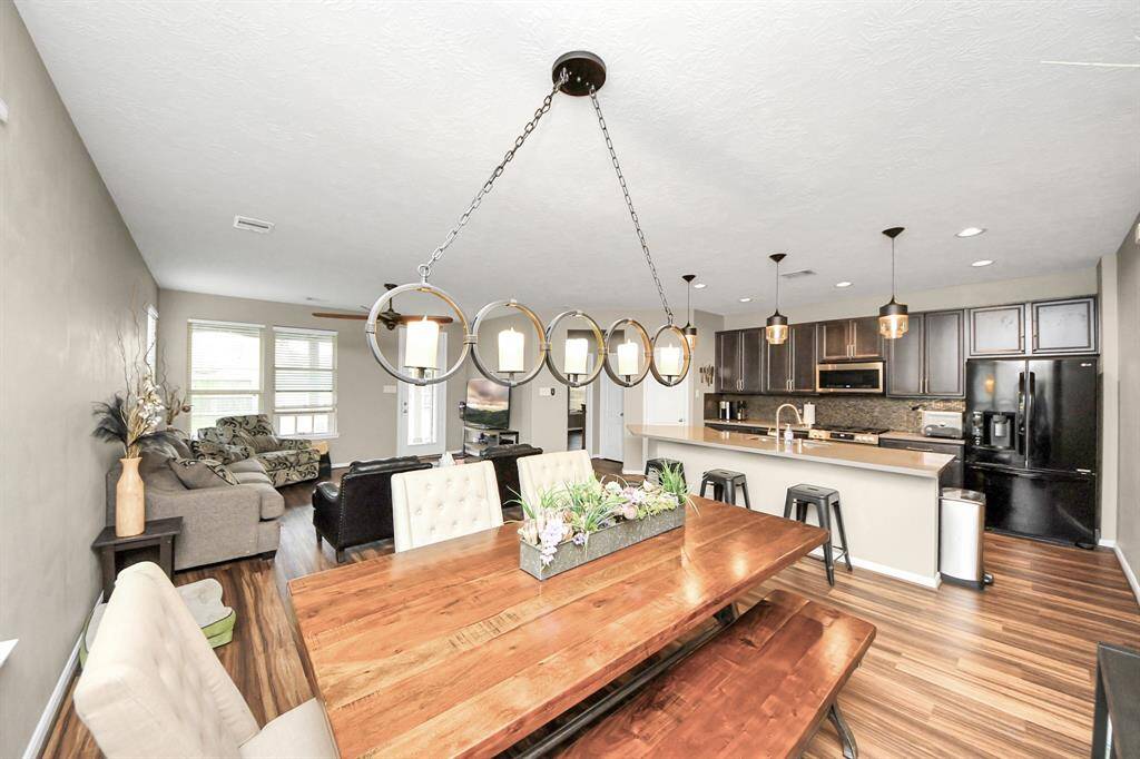 The dining room features large windows and beautiful lighting.