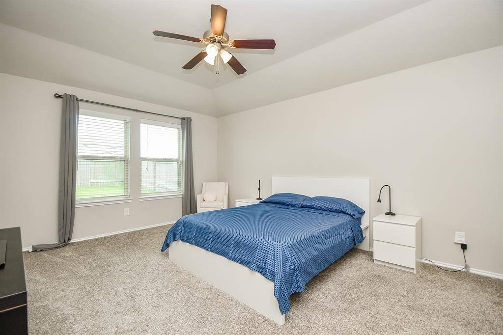 The master bedroom is large, spacious, and bright a great high ceiling and natural light.