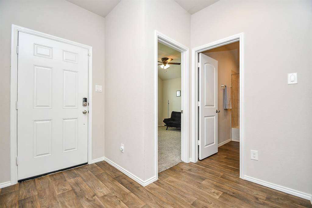Pale, cool walls are complemented by durable flooring in this view of the front entrance, from the inside.
