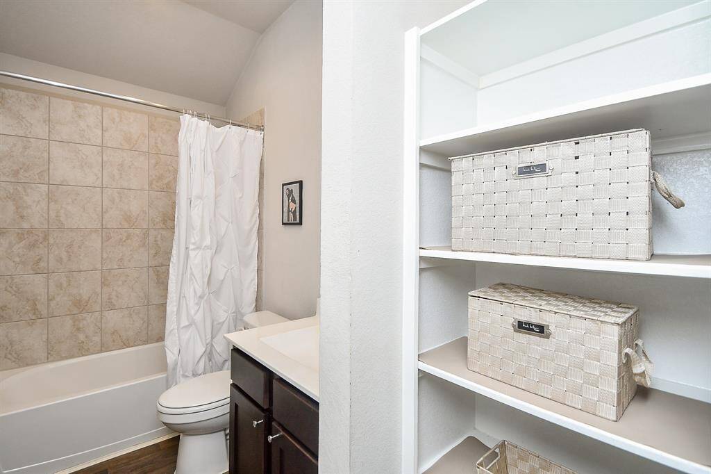This full 2nd bath offers all creature comforts, with combined shower/bathtub for easy personal options. And, look at the clever use of wall space for plenty of shelving and storage space.