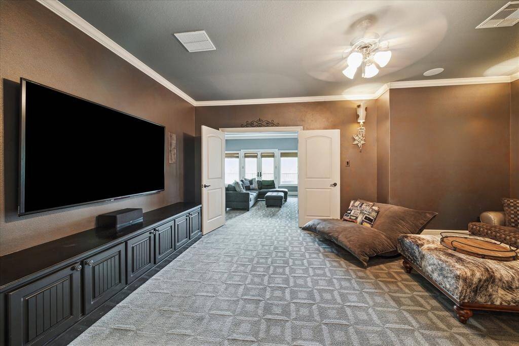 The dedicated media room is conveniently connected to the the game room but tucked away to ensure privacy and darkness when it's time to snuggle up for movie night. A 70" Sharp Aquos TV and Yamaha sound system with Klipsch 7 channel speaker system make this a true theatre experience. Luxurious designer carpeting and wall sconces create a relaxing atmosphere.