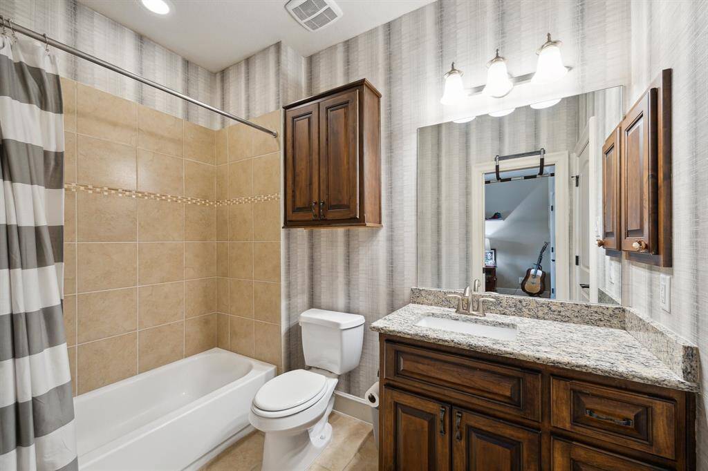 This spacious secondary bathroom has direct access to the secondary bedroom.  It also conveniently services the game room and media rooms.