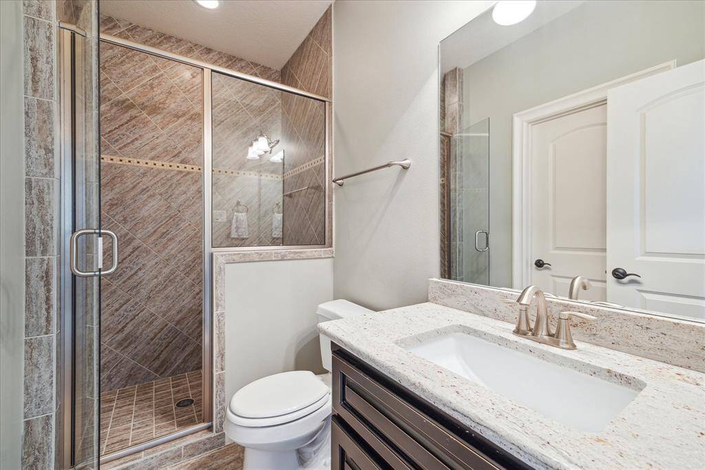 The neutral tones and finishes of this en-suite bath allow a clean slate for personalization. A walk-in closet is accessed from within.