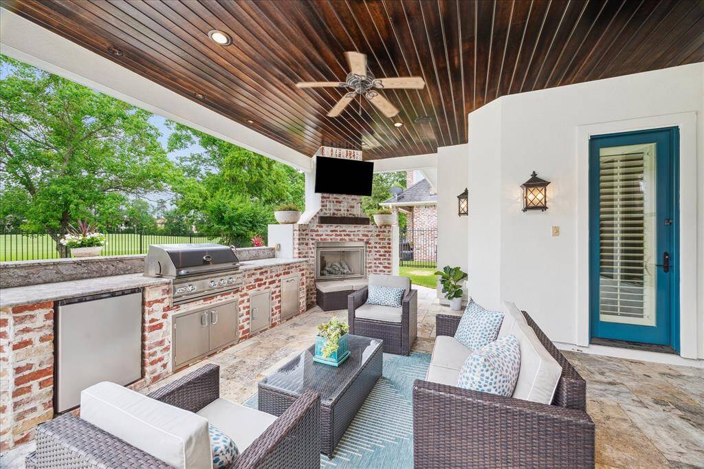 The Creole-styled outdoor kitchen is nestled below the 2nd floor balcony with tongue-and-groove wood ceiling. Protected from the elements, this is the perfect place to entertain or enjoy a glass of wine while anticipating what's to come off the grill. Just outside the kitchen and breakfast area, this beautifully appointed space features a RCS grill, refrigerator and gas fireplace.