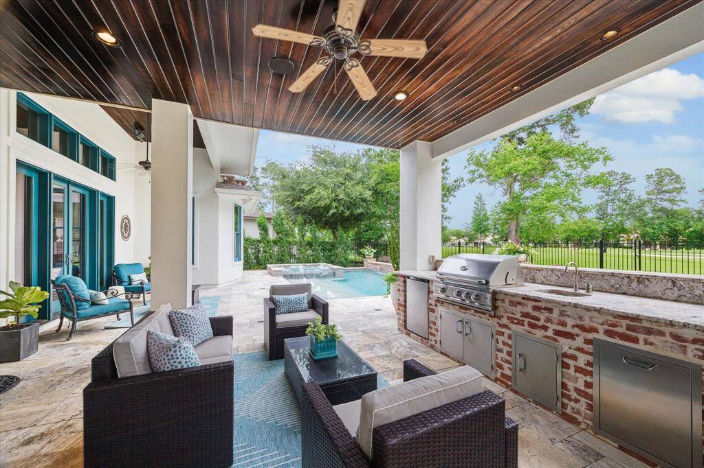 Multiple covered and exposed areas allow for versatility in design and use! The patio areas and pool are finished in timeless Travertine stone pavers that beautifully complement the classic Chicago brick of the summer kitchen and water feature wall.