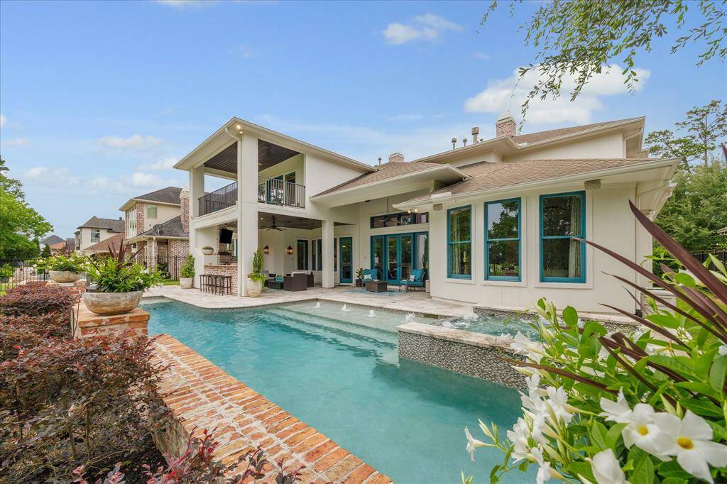The rear elevation of this estate is as pleasing as the front elevation. All covered patio ceilings are finished with stained tongue and groove millwork.
