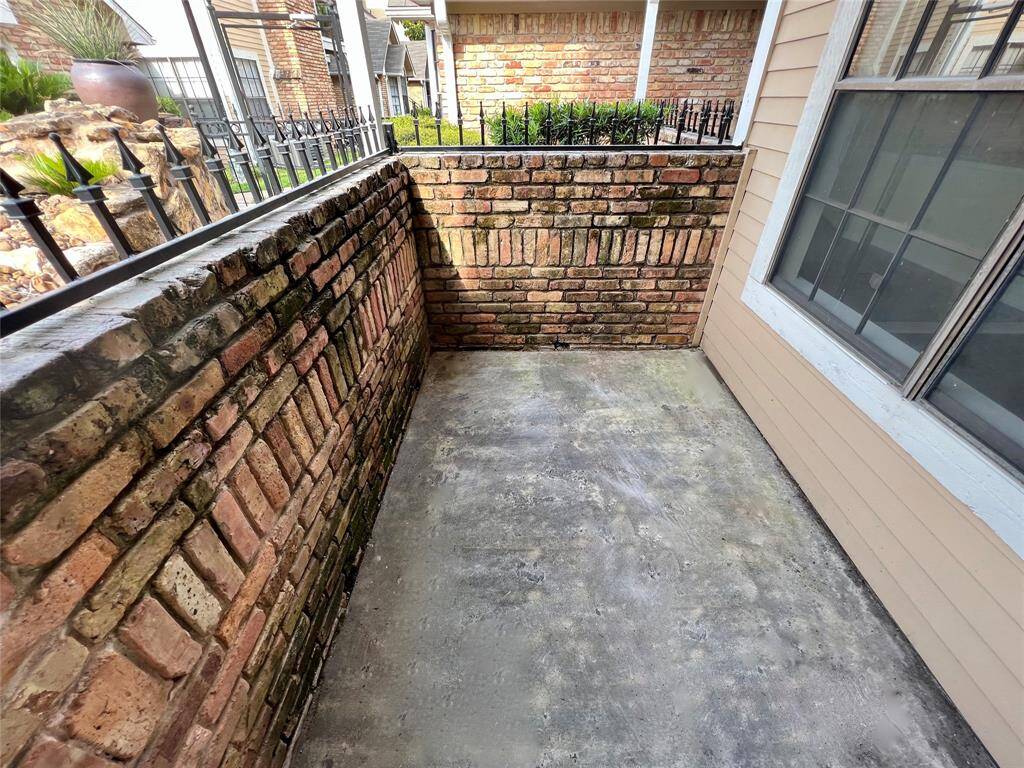 Covered patio overlooking community pool.