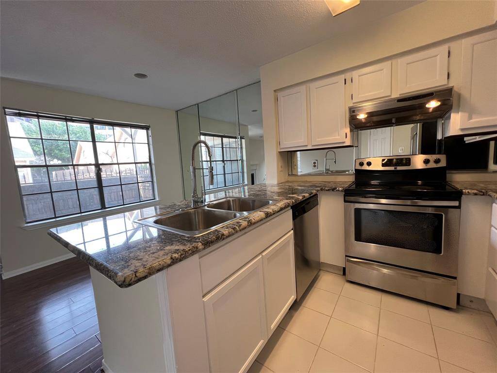 Stainless appliances, under-mount sink and commercial-style faucet.