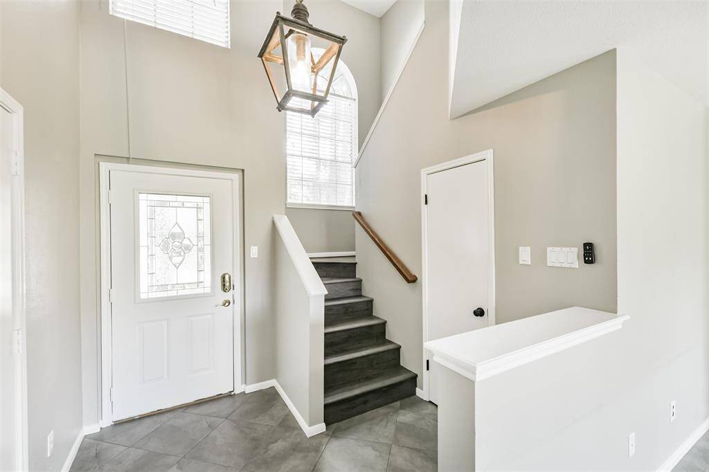 Entry Way With tall Ceilings, Guest Bathroom at bottom of the stairs