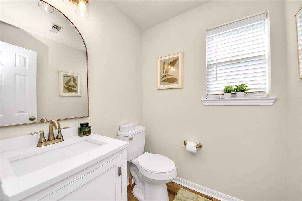 This handy half bath on the first floor sits right between key areas of the home, providing comfort and convenience for guests and family.