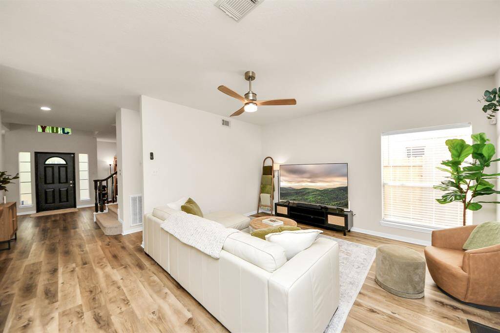 This open-concept living space is all about modern elegance — light, airy, and effortlessly stylish. From the sleek staircase to the gorgeous light-toned flooring, every detail creates a bright and inviting atmosphere you'll love coming home to.