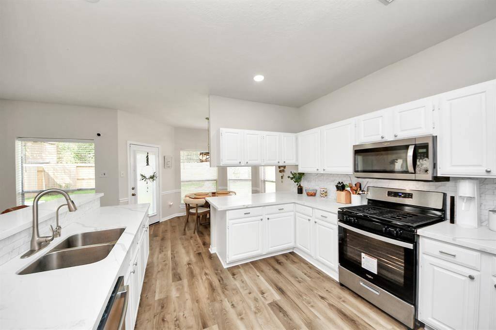 Another angle of the beautiful kitchen — offering ample space, sleek finishes, and an abundance of natural light.