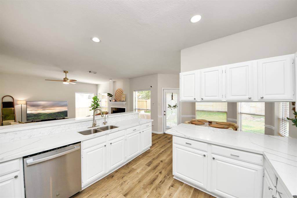 With plenty of natural light and soft recessed lighting, this kitchen feels open and fresh. The quartz countertops and stainless steel appliances make cooking here both stylish and simple.