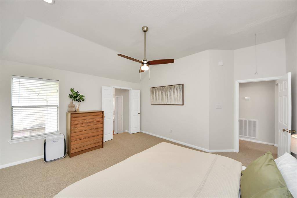 Another look at the primary bedroom highlights its spacious design and serene atmosphere.