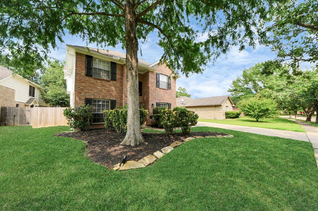 This beautiful home boasts undeniable curb appeal, featuring a classic brick exterior and a well-kept front yard.