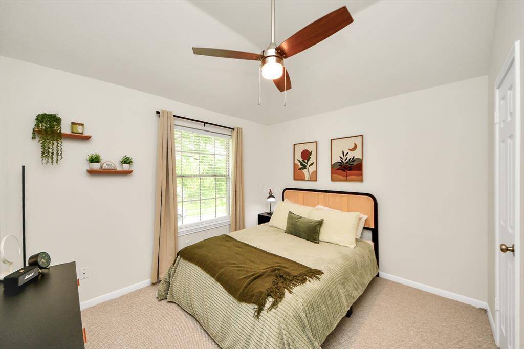 Step into the secondary bedroom, where natural light pours in through a large window, creating a bright and welcoming vibe. With generous space for flexible furniture layouts and a roomy closet for all your essentials, this room is as functional as it is inviting.
