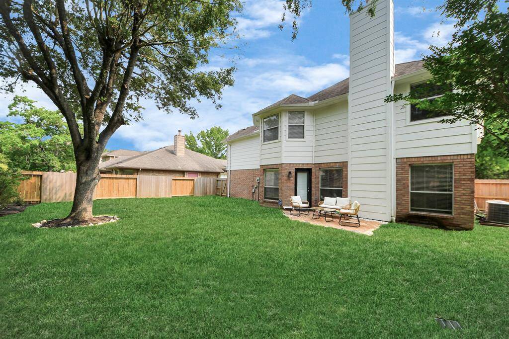 The backyard offers plenty of room for kids to play and enjoy outdoor activities, making it an ideal space for family fun.