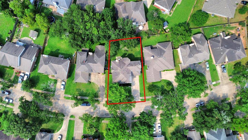 Aerial view of 235 Cedar Elm Ln—see the full picture of this beautiful home and its spacious surroundings.