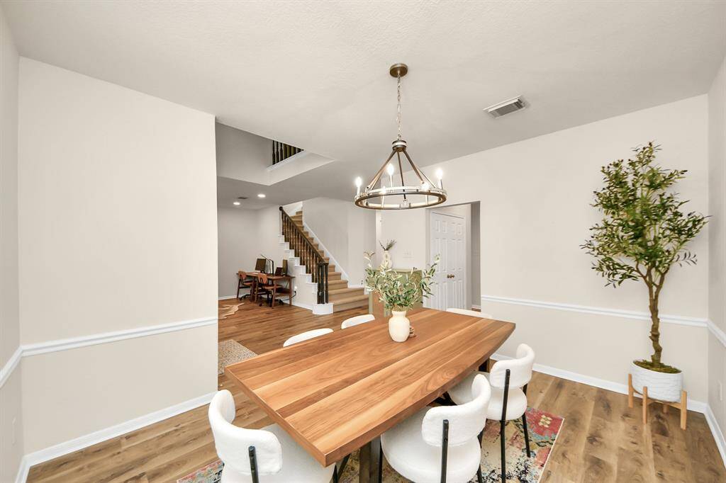 Just off the entry, the formal dining room offers the perfect setting for gatherings, with room to easily fit a full-sized dining set. Modern light fixtures add a stylish edge, and the large front-facing window fills the space with soft, natural light.