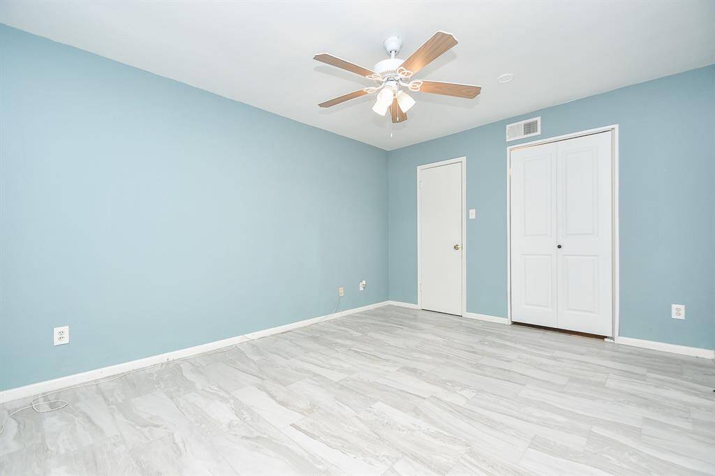 Marble-look tile floors ornament the primary bedroom!
