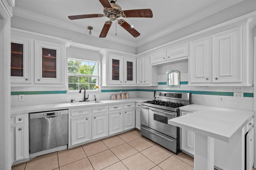 The view from the kitchen window, paired with abundant natural light, creates a tranquil ambiance that complements the fresh updates—enhancing the space without losing its timeless farmhouse charm.