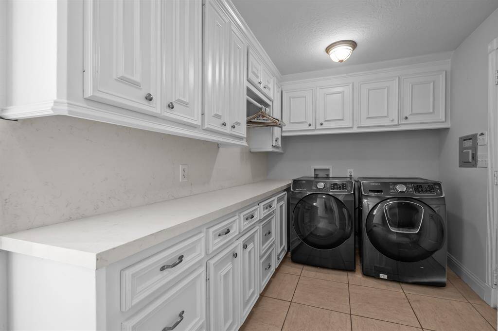 The updates extend to the utility room just off the kitchen, where granite countertops and ample storage help make the never-ending task of laundry feel totally manageable—even enjoyable.
