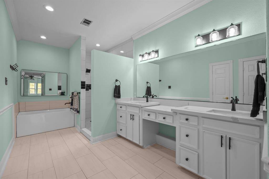 The primary bath has been fully renovated and features a new double-sink vanity with granite countertops, a luxurious fully tiled walk-in shower, a modern soaking tub, and all-new fixtures for a spa-like experience.