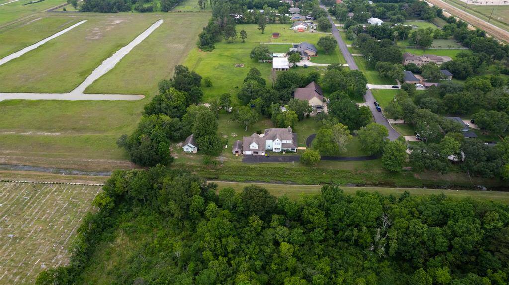 Breathtaking aerial views showcase the rare privilege of living tucked away in one of Pearland’s most established areas—surrounded by lush green space with no neighbors to the right or behind. Peace, privacy, and endless greenery await.