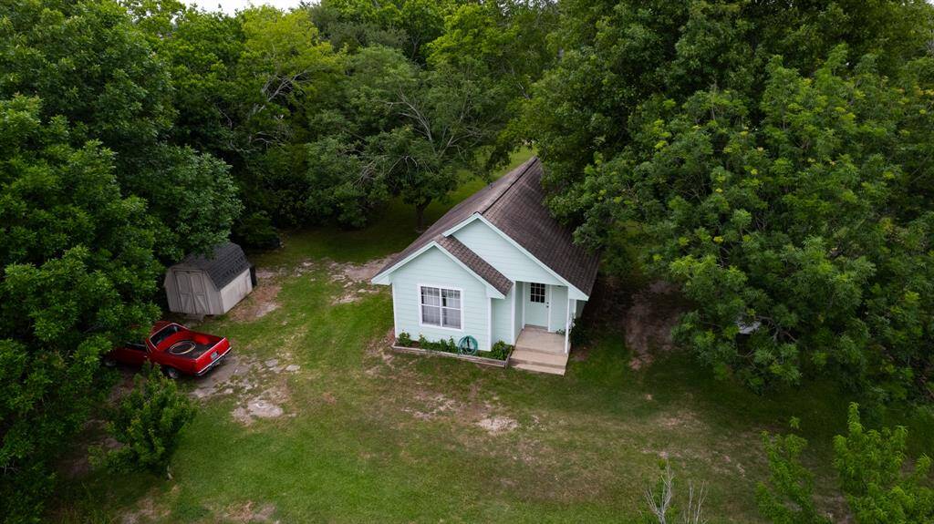 Breathtaking aerial views showcase the rare privilege of living tucked away in one of Pearland’s most established areas—surrounded by lush green space with no neighbors to the right or behind. Peace, privacy, and endless greenery await.