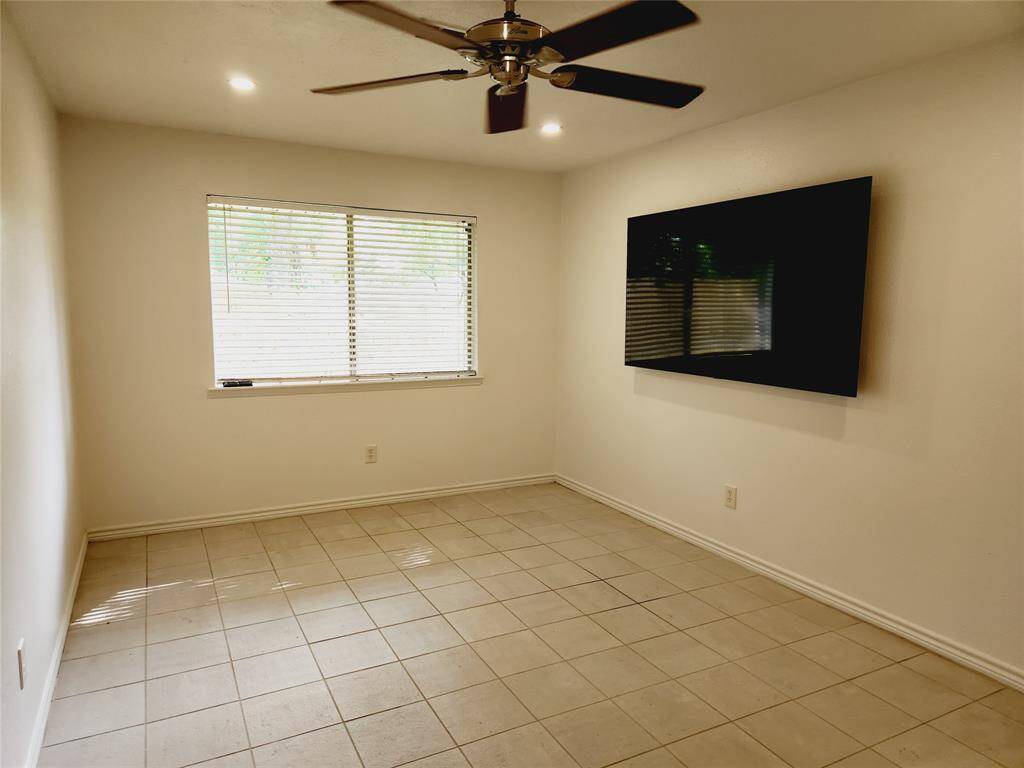 Primary Bedroom with mounted television