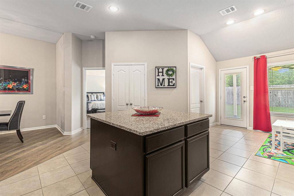 Awesome central island with double-sided storage and granite countertop that's perfect for prepping and serving your delicious creations!