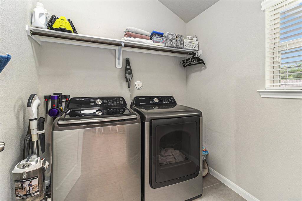 Spacious utility room with window to backyard