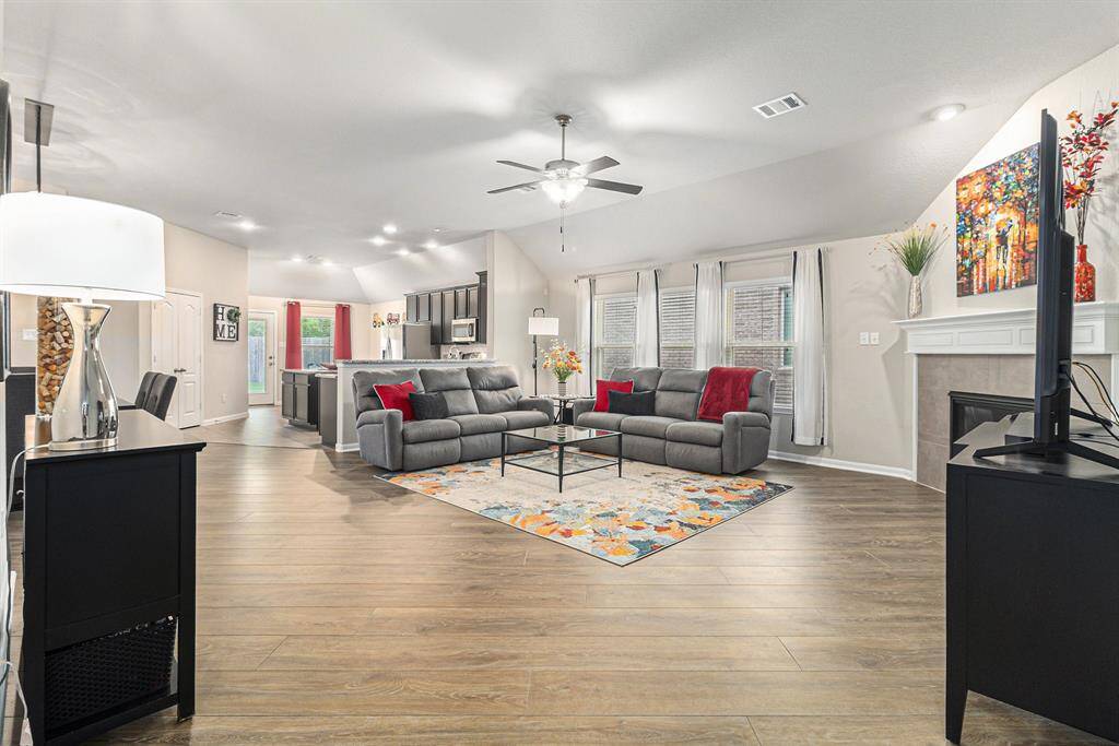 This spacious open-concept living area features gorgeous RevWood Plus flooring in "Kindling Oak" in the living room and dining room.
