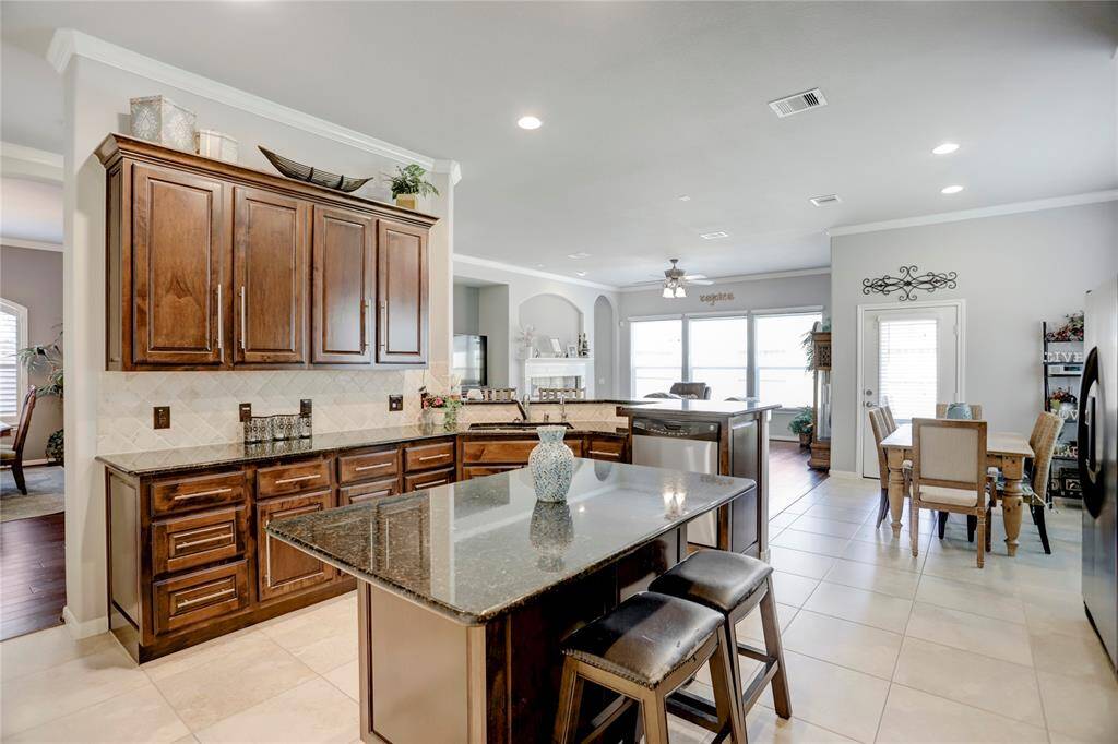 This photo showcases the home open concept kitchen, seamlessly connecting to the dining area, and offering a modern and inviting space for cooking and entertaining.