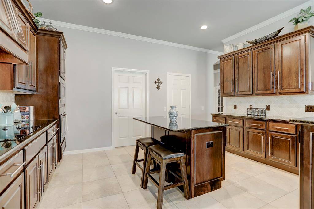 The kitchen is well-lit and includes modern appliances, with a neutral palette offering a clean and inviting atmosphere.