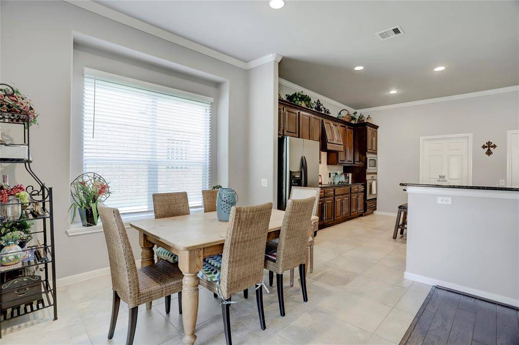 The area features a large window, neutral wall colors, and easy-to-maintain tile flooring.