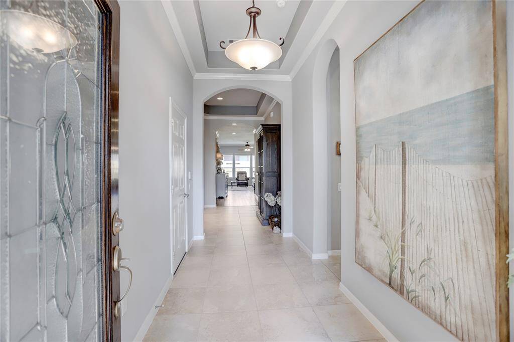 A bright, elegant foyer invites you into one of the more unique floor plans in the neighborhood.