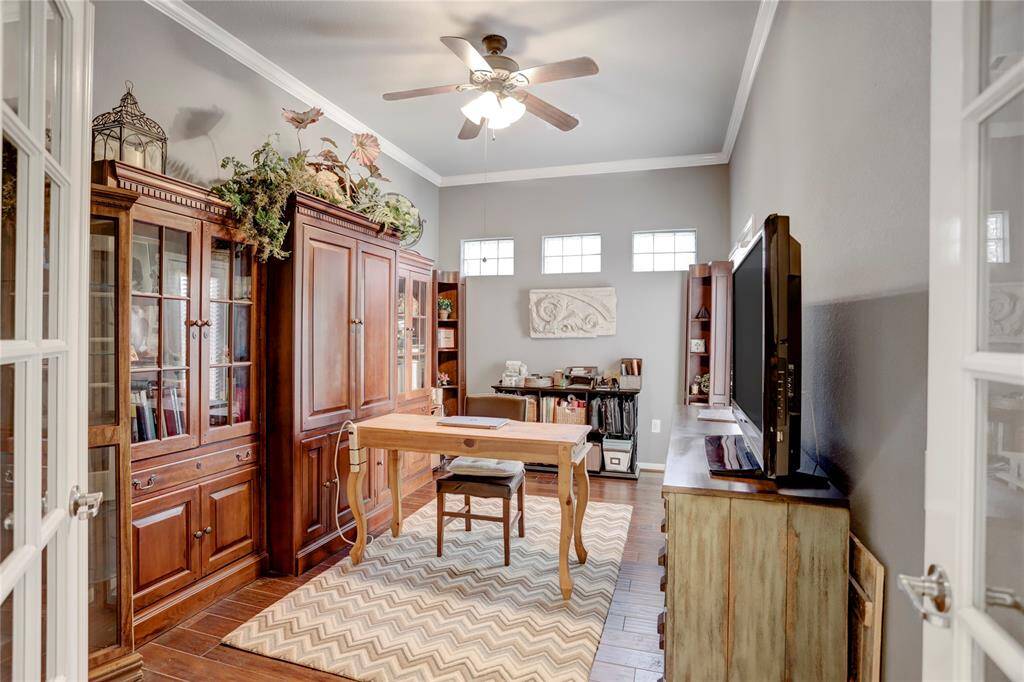 This bright sudy features high ceilings, engineered hardwood floors, and plenty of natural light from the upper windows.
