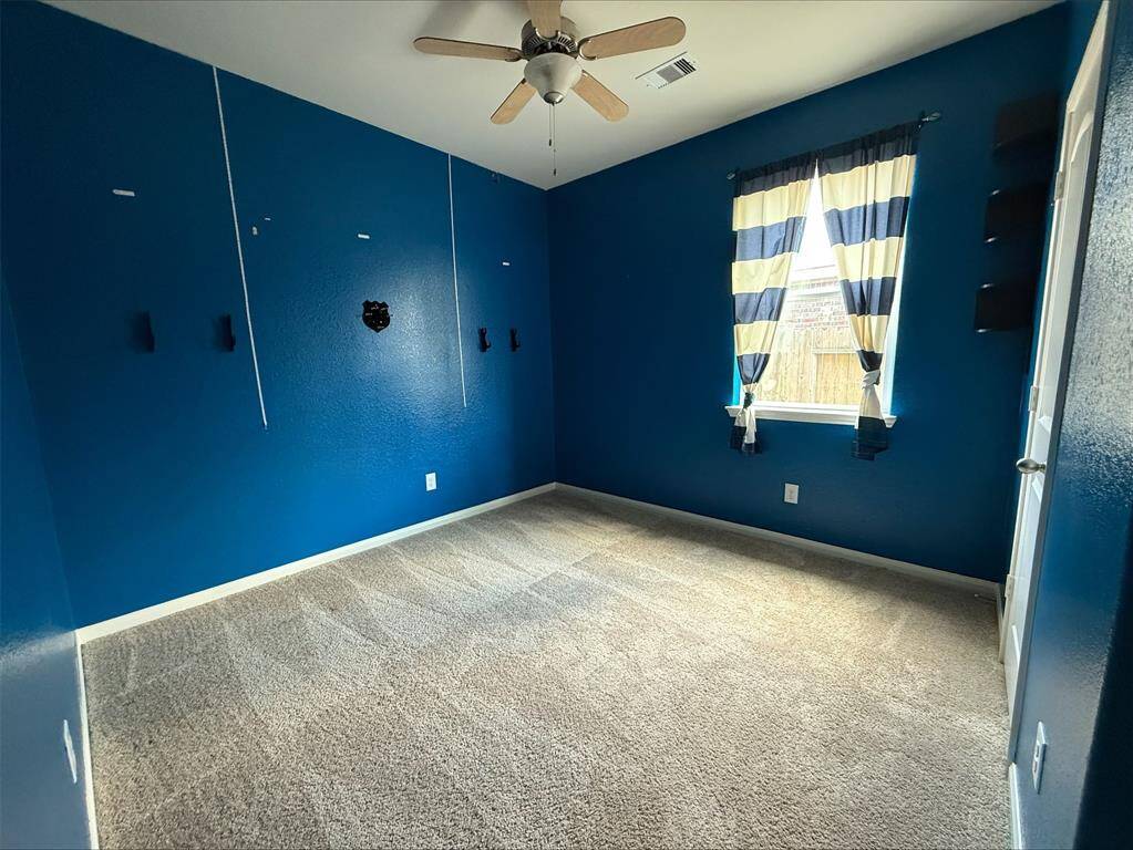 Bedroom 3 with carpet and ceiling fan. Generous sized closets.