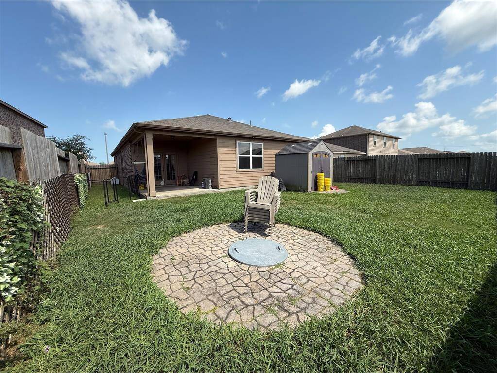 Fully fenced backyard with covered porch.