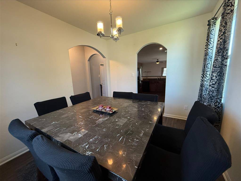 Formal dining with easy access to kitchen. Notice decorative arches.