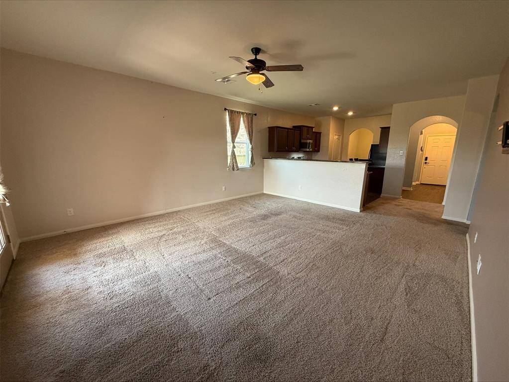 Spacious main living area with carpeting.