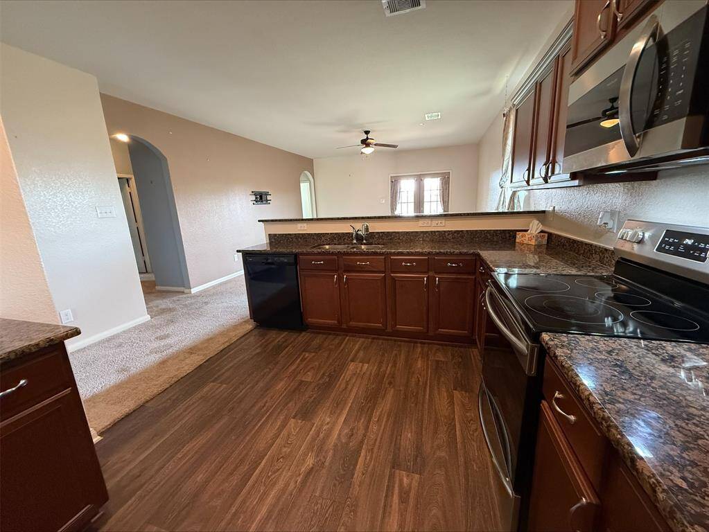 Kitchen with electric range and built in microwave. Refrigerator included.