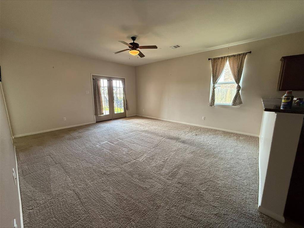 Main living area has french doors leading to covered patio and back yard.